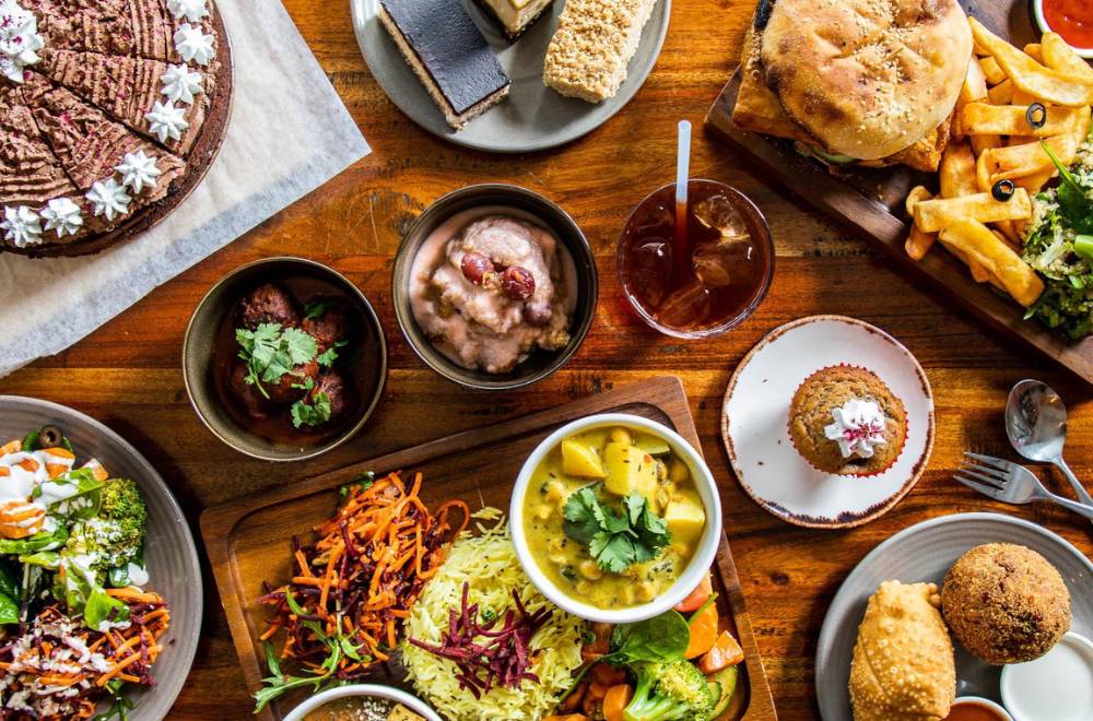 Plates of vegan food fills the table.